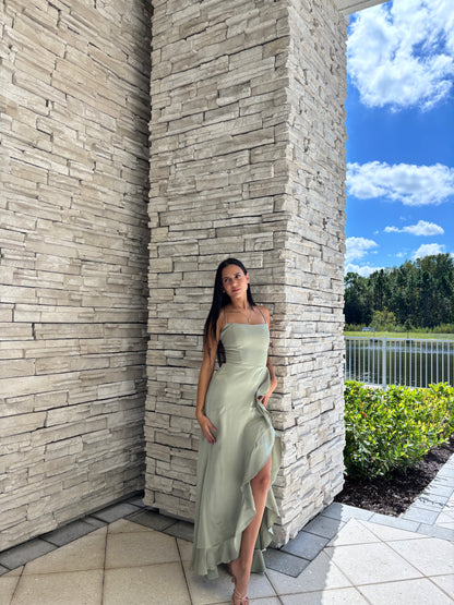 Sage satin maxi dress with a corset bodice, ruffled surplice skirt, and open back tie details, perfect for formal spring occasions