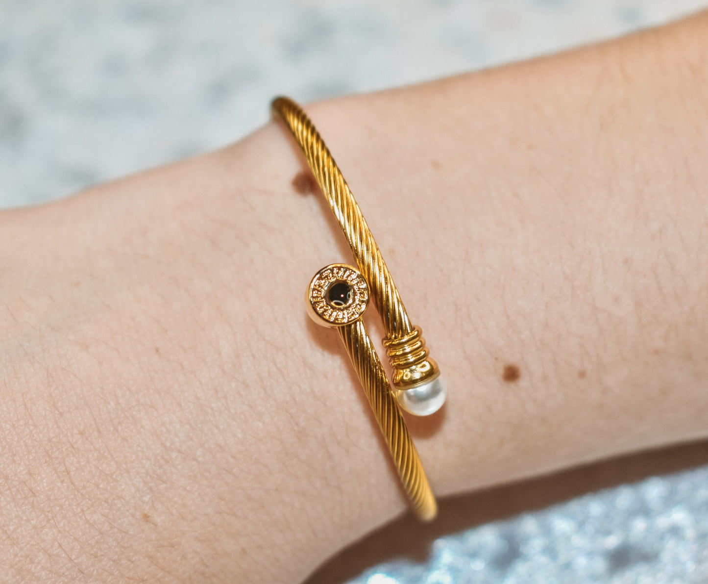 Gold cuff bracelet with ring