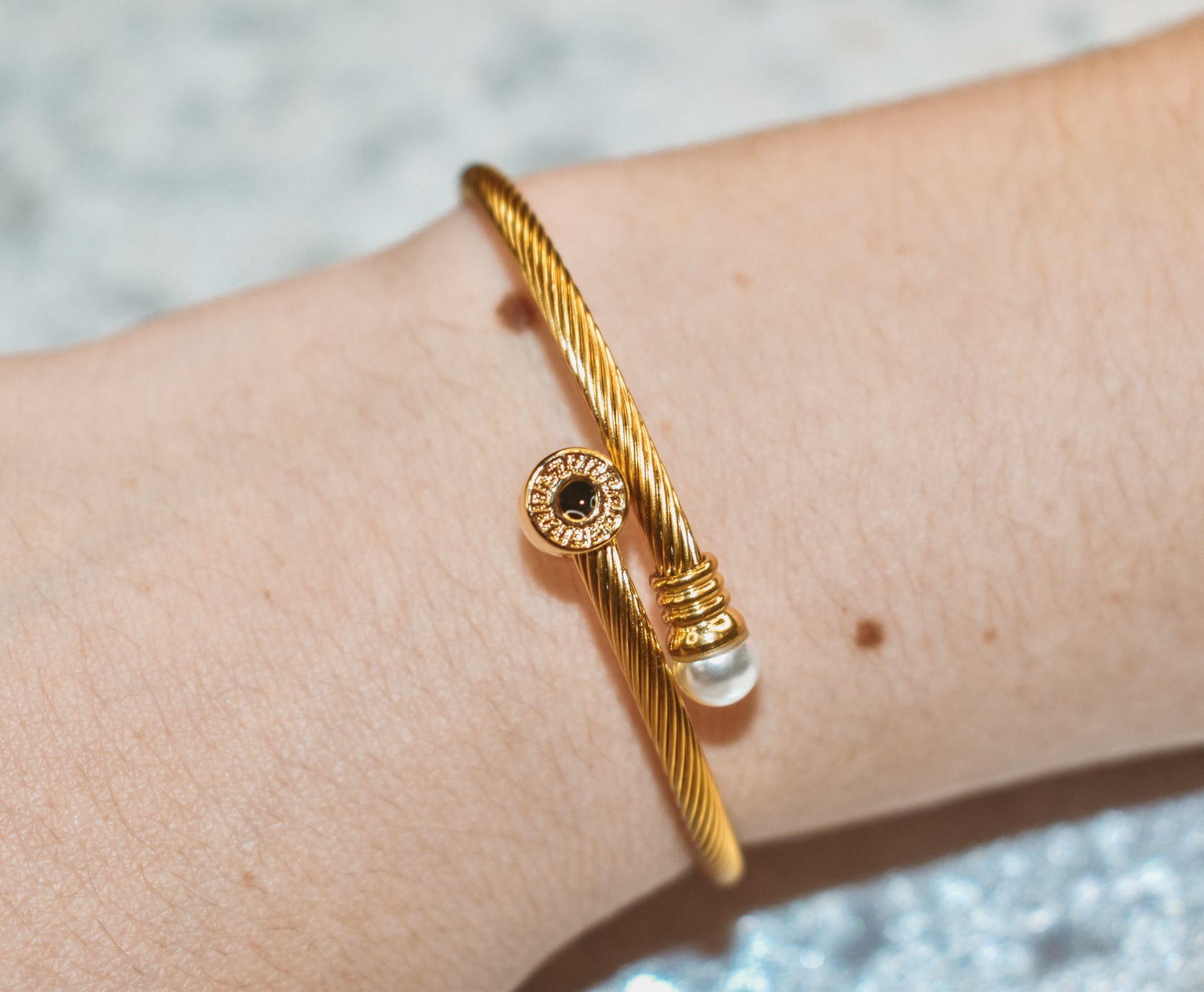 Gold cuff bracelet with ring